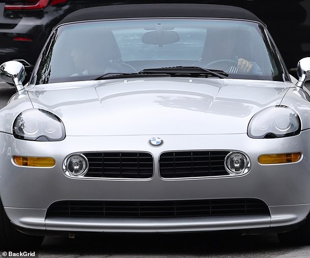 Off they go: Kevin was spotted driving his son off in a gleaming silver BMW after their brunch