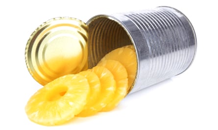 Pineapple rings spilling out of a can.