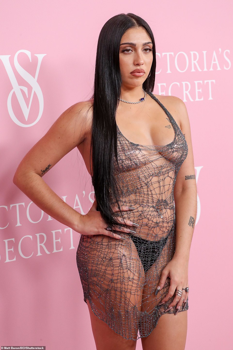 Chrome: The model sported a chrome claw-like manicure and decked out her hands in silver rings