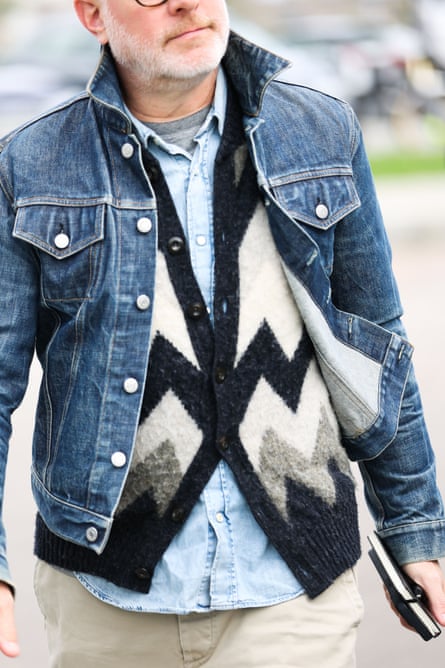 Man wearing a T-shirt, shirt, cardigan and jacket