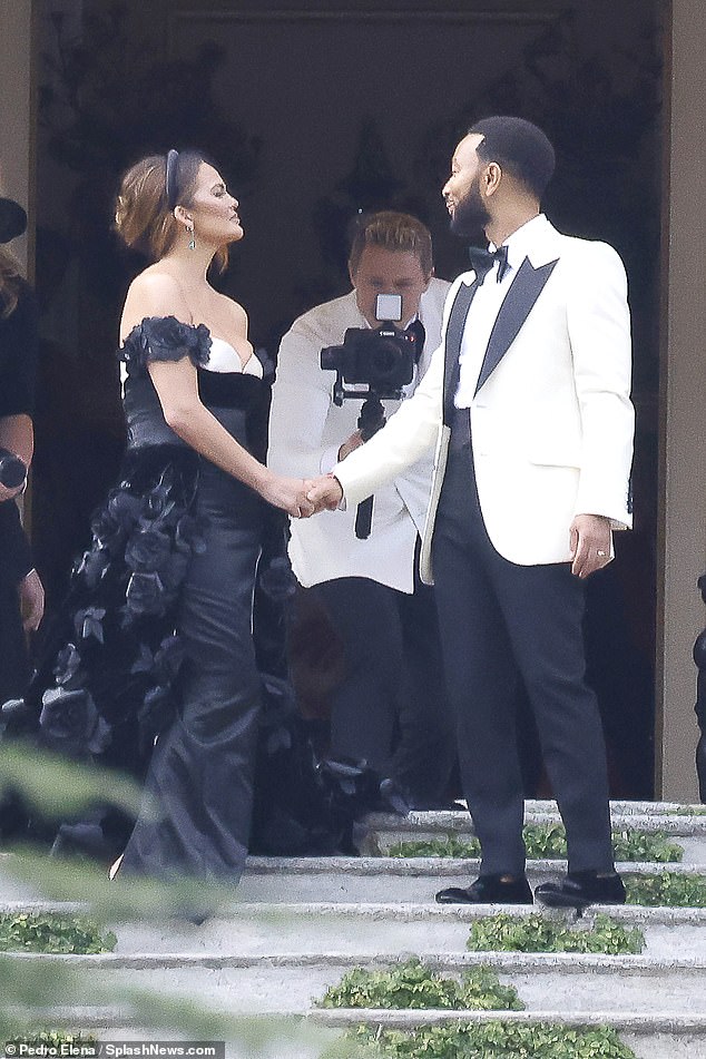 Vow look: When the Sports Illustrated Swimsuit Issue model got to the villa for the ceremony she changed into a long, off the shoulder black dress featuring a hint of white at the bust and a train covered in black rosettes