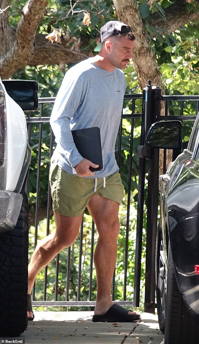 Lavender Haze: The professional football player cut a casual figure in shorts, a long-sleeved tee and a backwards baseball hat as he headed inside his Kansas City home solo following a training session