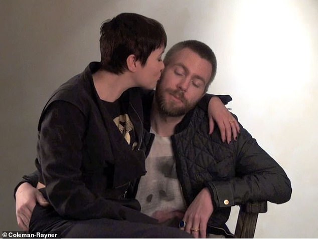 At the end of the interview, he introduced his wife to the camera and she sits on his knee and gives him a kiss on the cheek