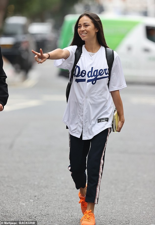 Thrilled: Katya Jones, 34, put on a sporty display in a graphic white T-shirt as she departed Radio 5 Live Studios on Sunday
