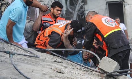 Palestinian emergency services and local citizens search for victims in buildings destroyed during Israeli raids in the southern Gaza Strip on 18 October 2023 in Khan Yunis, Gaza.