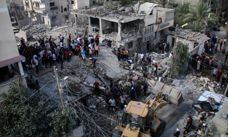 Palestinian emergency services and local citizens search for victims in buildings destroyed during Israeli air raids in the southern Gaza Strip on 18 October 2023 in Khan Yunis, Gaza.