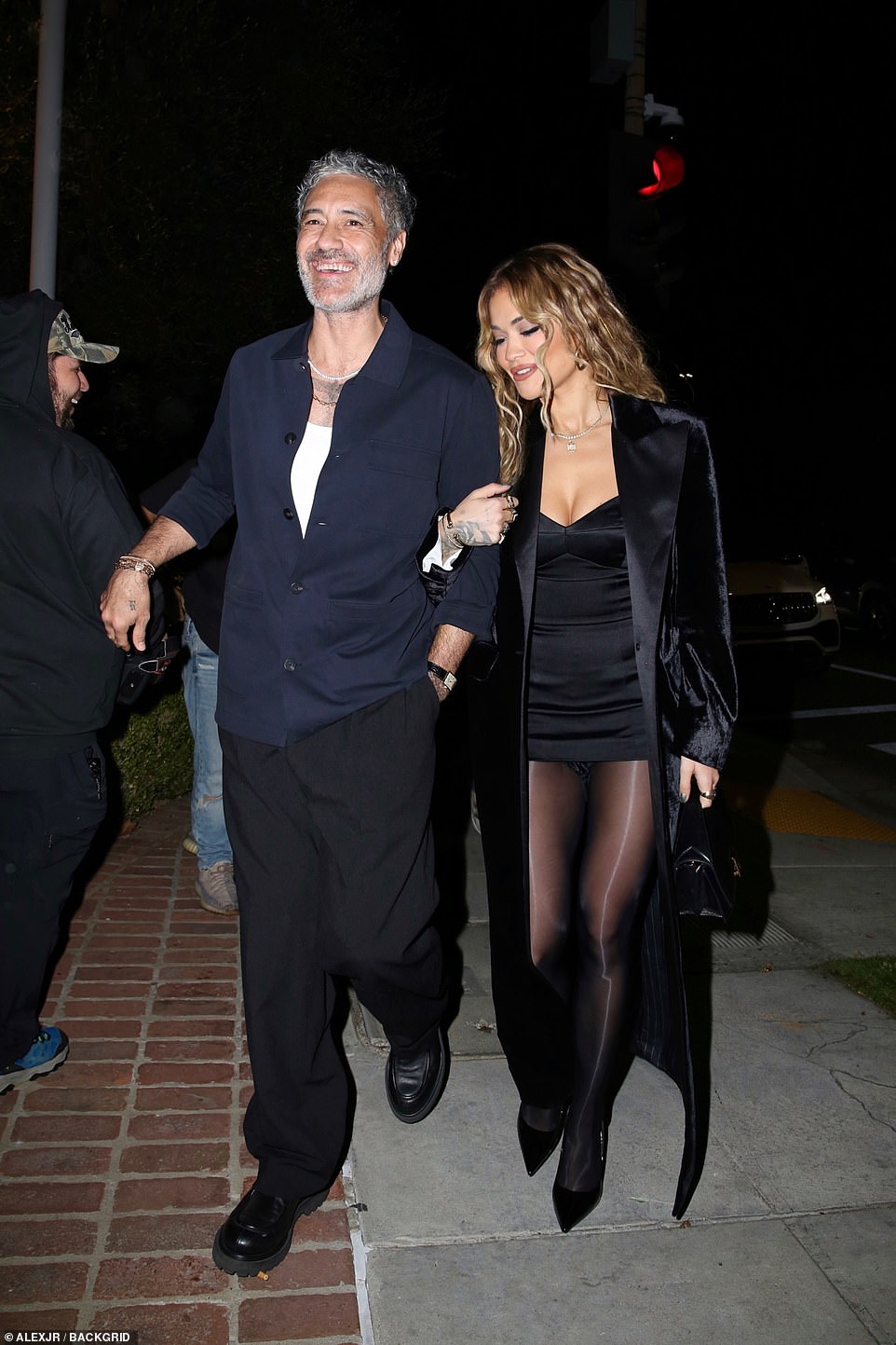 Legs for days: Rita put on a leggy display in the look, slipping her stems into a pair of sheer black pantyhose