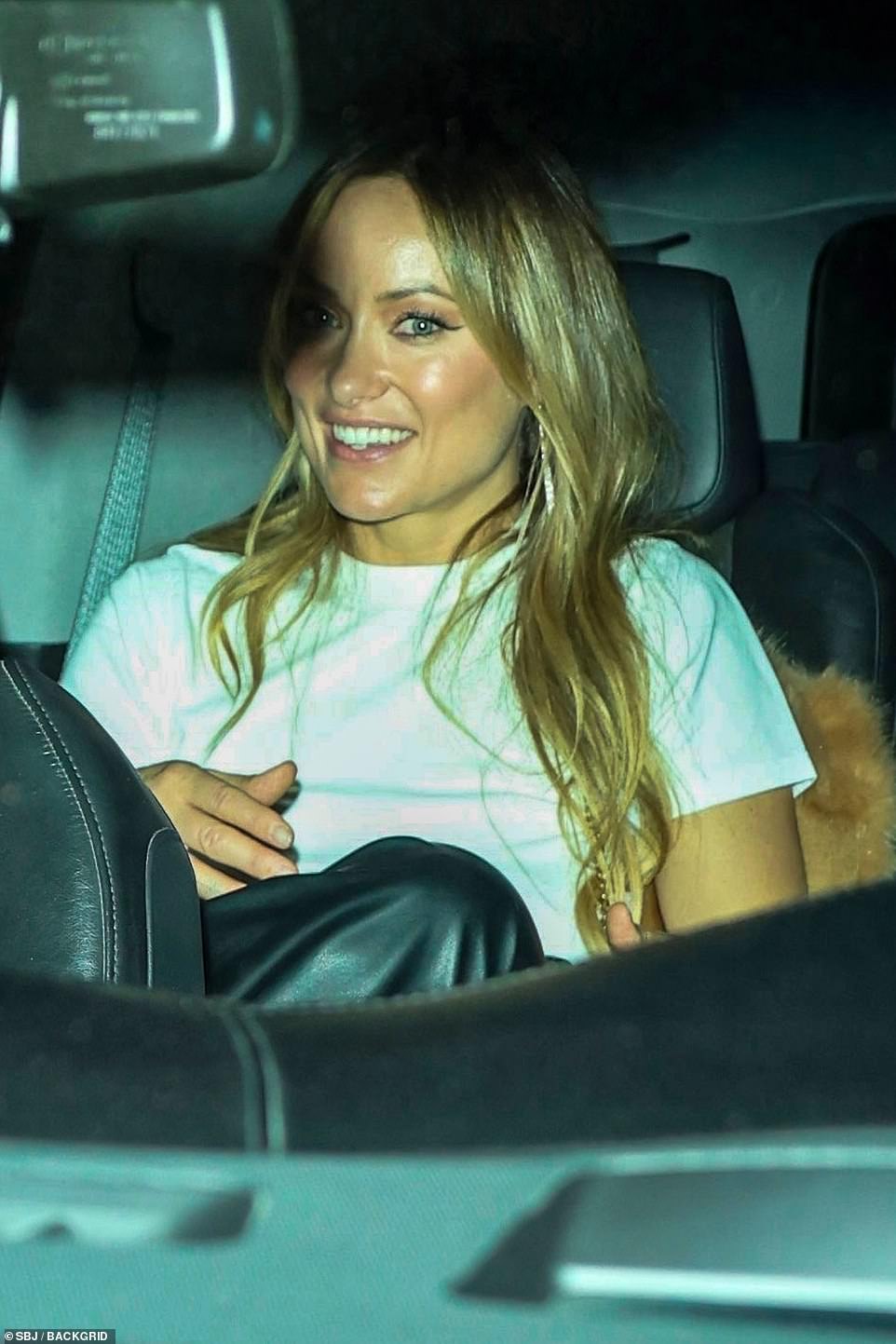 Good spirits! She departed the bash in the same car as Rock
