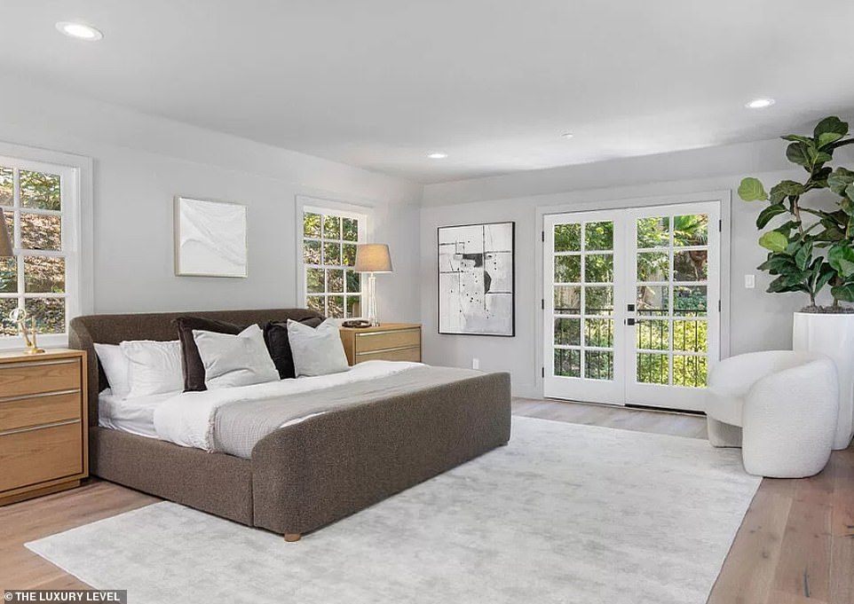 The bedroom includes a Juliet balcony that overlooks the swimming pool