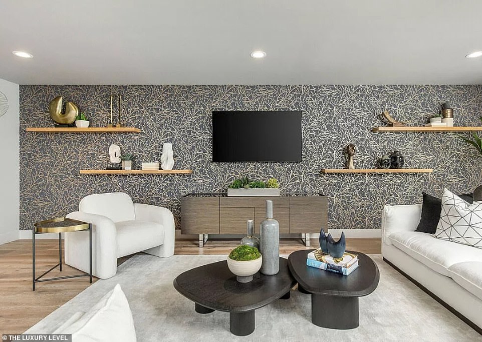 The main floor accommodates three bedrooms and bathrooms, while the upper floor features a private primary suite