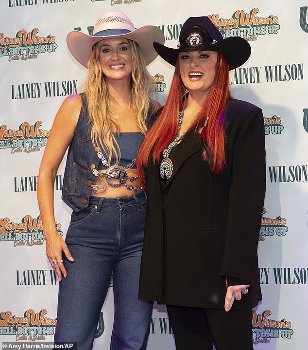 Judd added: 'I'm like, "What the hell are you doing? Where are you and why are you not here? And why are we not singing together again?"' Lainey Wilson, left, and Judd at the CMA Fest on June 9 in Nashville