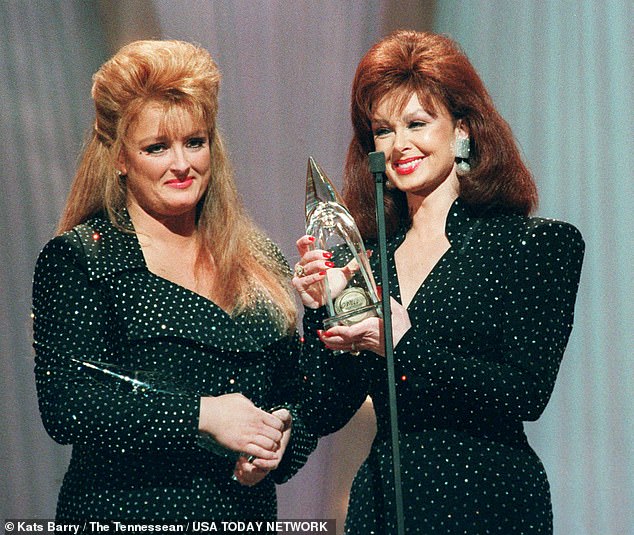 Wynonna, left, and Naomi Judd, right, accepted their eighth consecutive CMA award during the 25th annual CMA Awards show at the Grand Ole Opry House in 1991