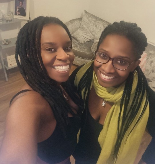 Kimberley Kinloch taking a selfie with her sister. Both are smiling and wearing black tops, while Kimberley wears a green scarf