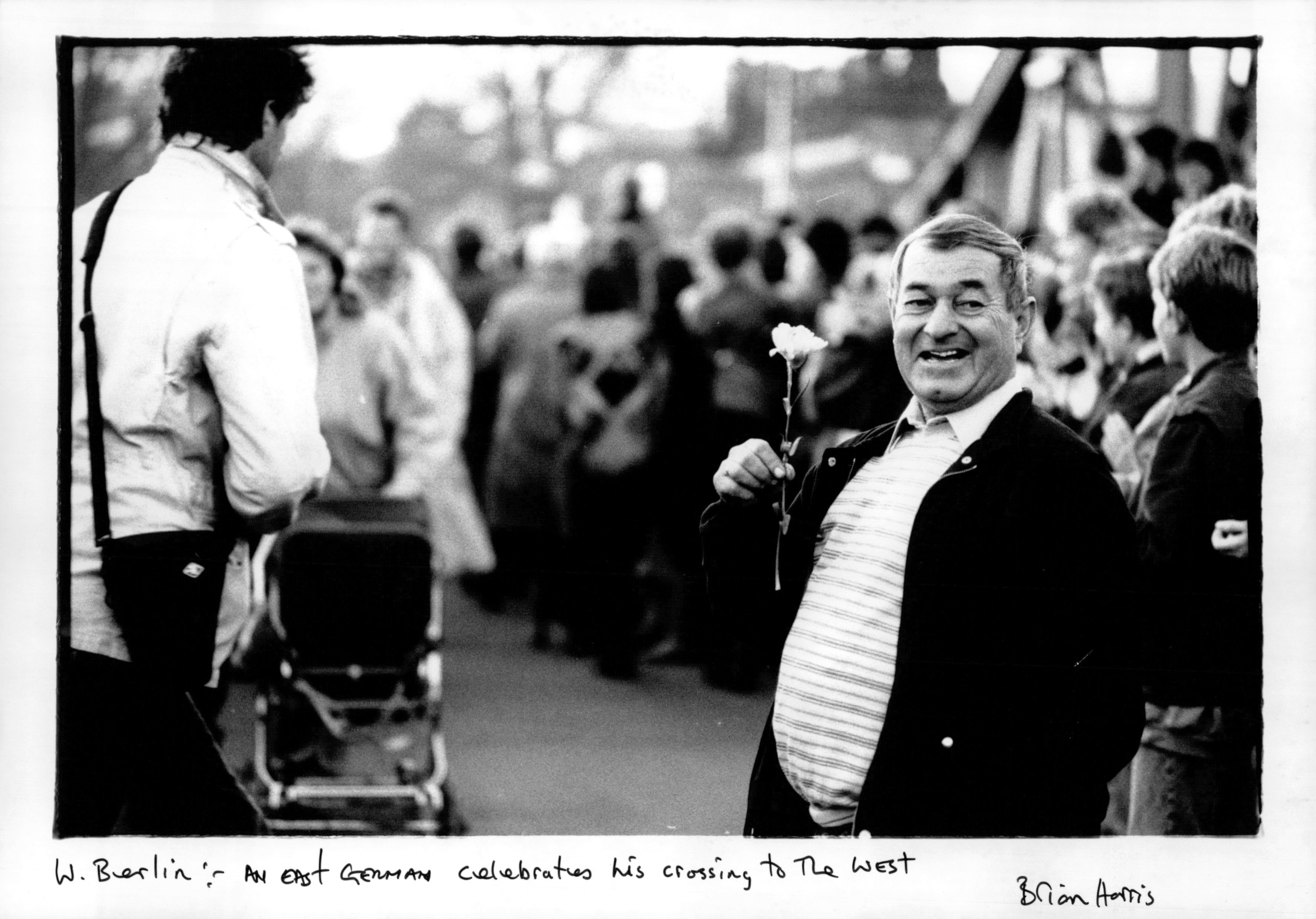 An East German celebrates his crossing into West Berlin