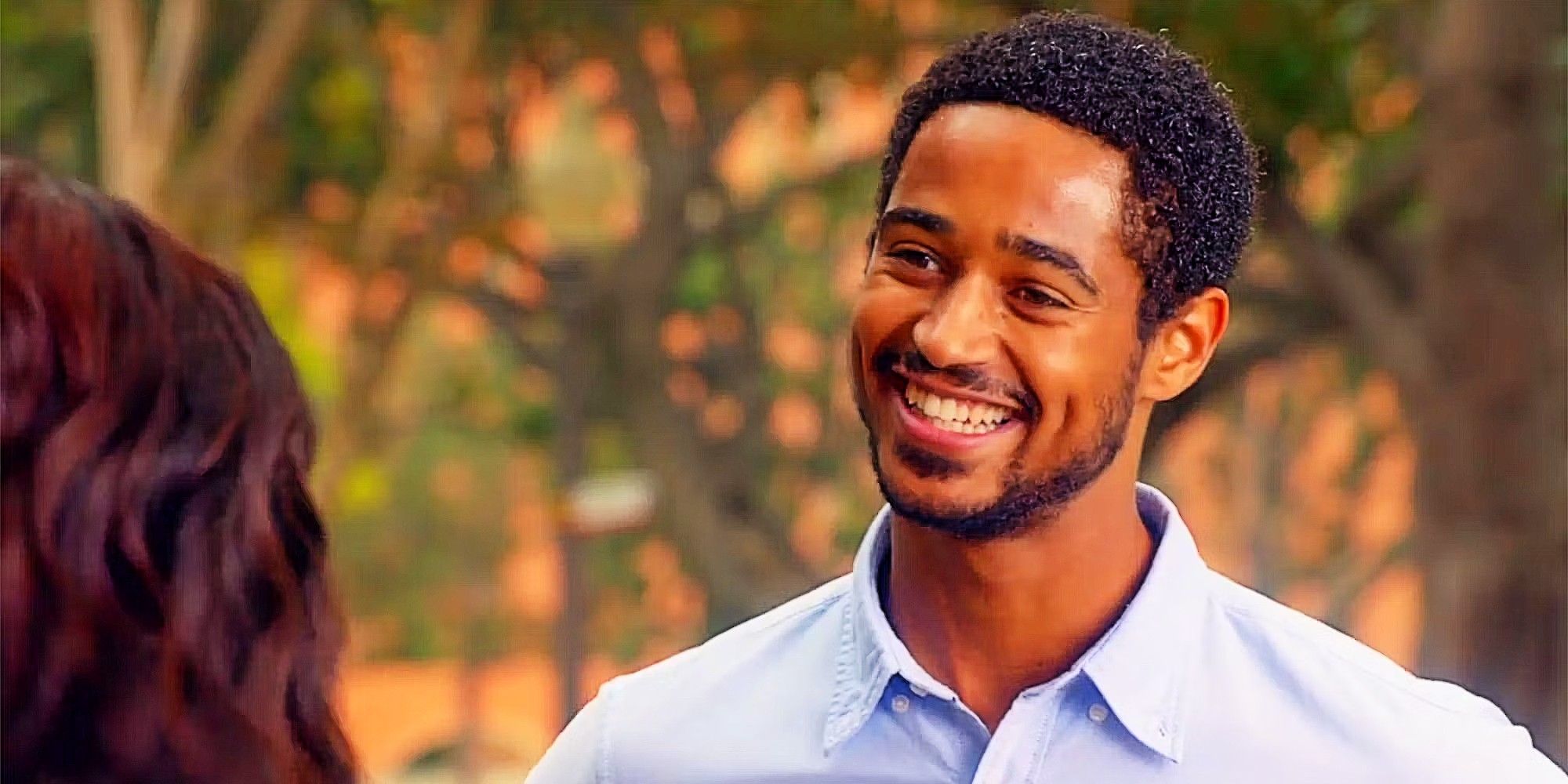 Wes Gibbins smiling and talking to someone in How to Get Away With Murder. 