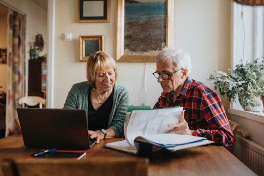 Senior couple using laptop at home