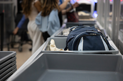 A bag in a tray going through airport security.