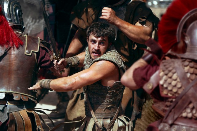 Paul Mescal as Lucius in the thick of a battle with a sword in a scene from Gladiator II