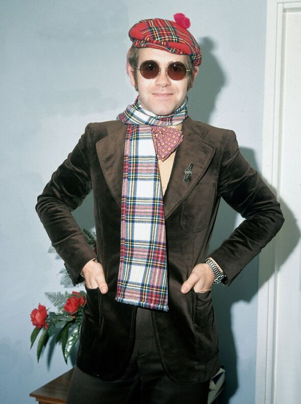 Elton John wearing tartan hat and cap March 1979