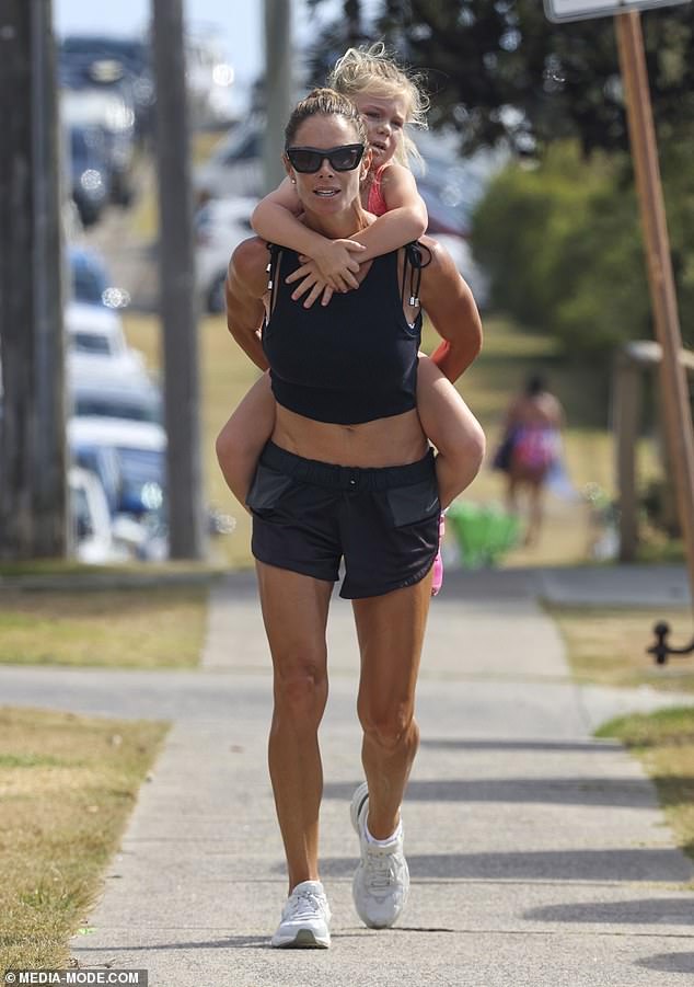 As the mother-of-three flaunted her toned tummy in a black crop top, she matched it with a pair of tiny black shorts