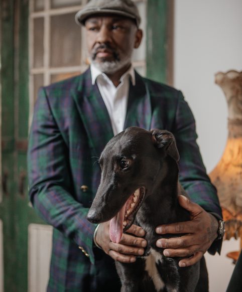 Lifestyle portrait of handsome black man with his dog