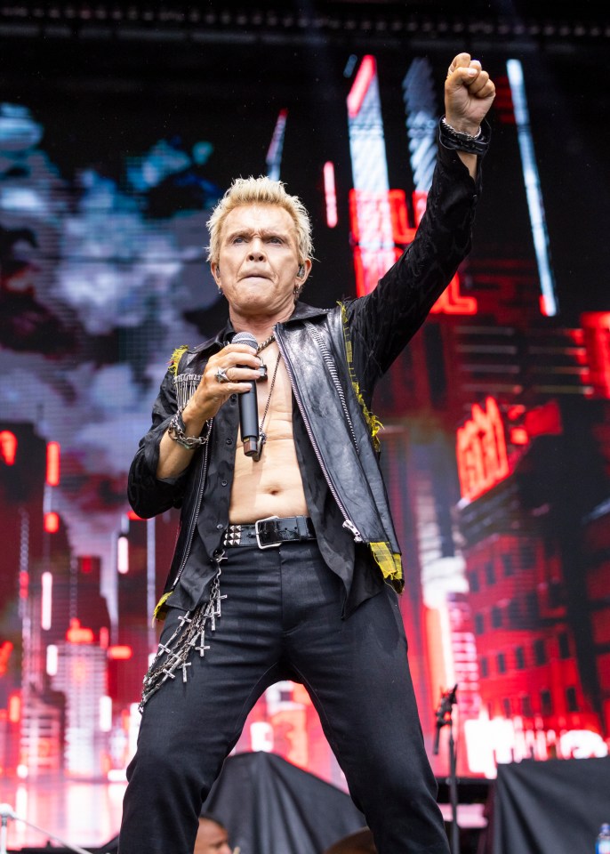 Billy Idol performing at a music festival.