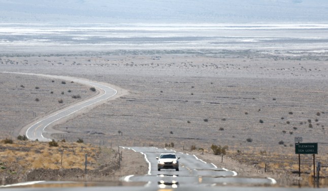 DEATH VALLEY, CALIFORNIA - JULY 09: A vehicle drives as heat waves shimmer, causing visual distortion, during a long-duration heat wave which is impacting much of California, on July 9, 2024 in Death Valley National Park, California. Park visitors have been warned, ???Travel prepared to survive??? as temperatures are predicted to reach close to record highs this week. Death Valley is the hottest and driest place in the United States. (Photo by Mario Tama/Getty Images)