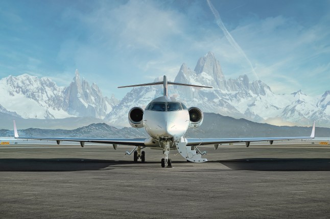 private jet on rnway with mountaints in the background