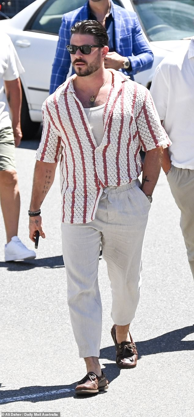 Paul looked effortlessly stylish in a short-sleeved red and white striped button-up shirt, which he left partially unbuttoned to reveal a hint of his toned physique