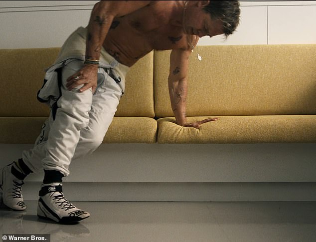 The character shows his pain after a race while collapsing on a sofa