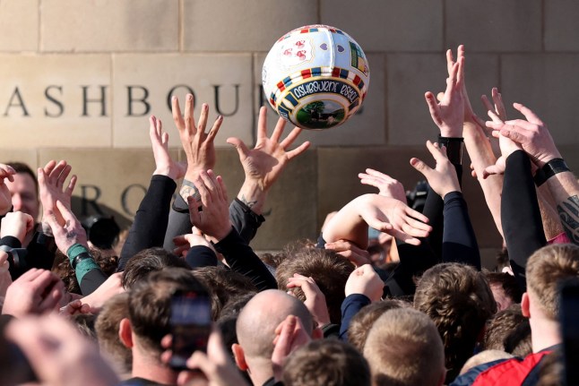 Annual Shrovetide Football match - Ashbourne, Britain - March 4, 2025 Players from the Up'ards and Down'ards teams compete for the ball during the annual Royal Shrovetide football match REUTERS/Phil Noble