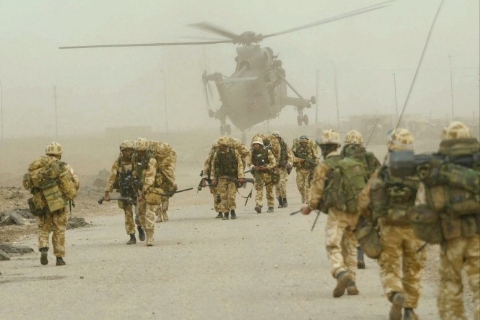 British troops in Iraq in 2003. They are approaching a helicopter in the desert