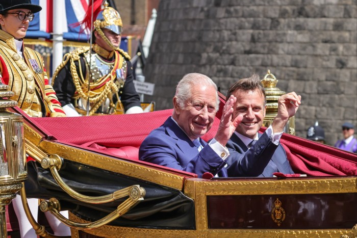 King Charles and Emmanuel Macron in an open-top carriage