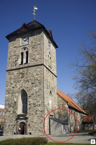 Bilde av en kirke, hvor det er ringet rundt påbygget hvor doen er.