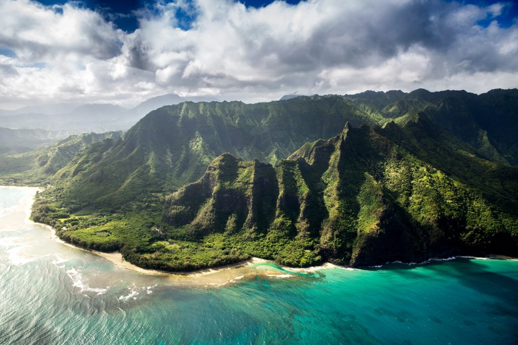 Gorgeous view of Hawaiian hilltops with turquoise ocean and blue skies