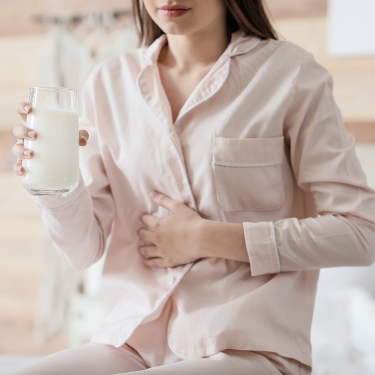 Young girl drinking milk and getting stomach ache, milk allergy