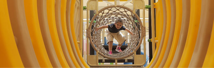 Student on play equipment at Nün Academy International School