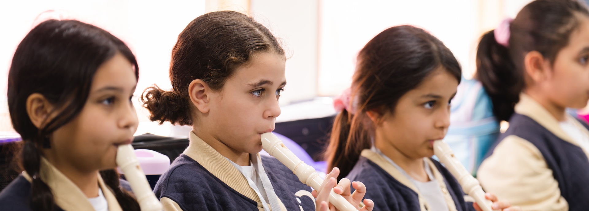 Students playing musical instruments at Nün Academy International School