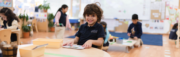 Student smiling, enjoying his work