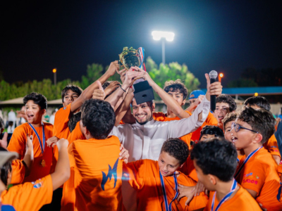 Nün Academy International School sports team lifting a trophy