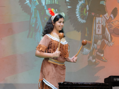 Nün Academy International School student performing on stage