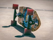 shallow focus photography of brown and blue skateboard