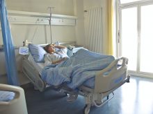 photo of woman lying in hospital bed