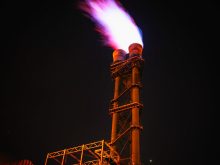 low angle view of illuminated tower against sky at night