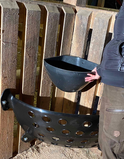 Photo of hay feeder and pellet trough