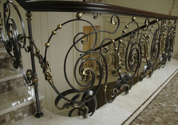 Wrought iron balustrade with wooden handrail “Dance” detail above
