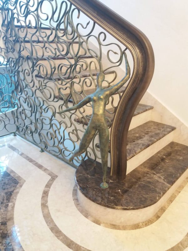 Wrought iron balustrade with wooden handrail “Spider web” detail