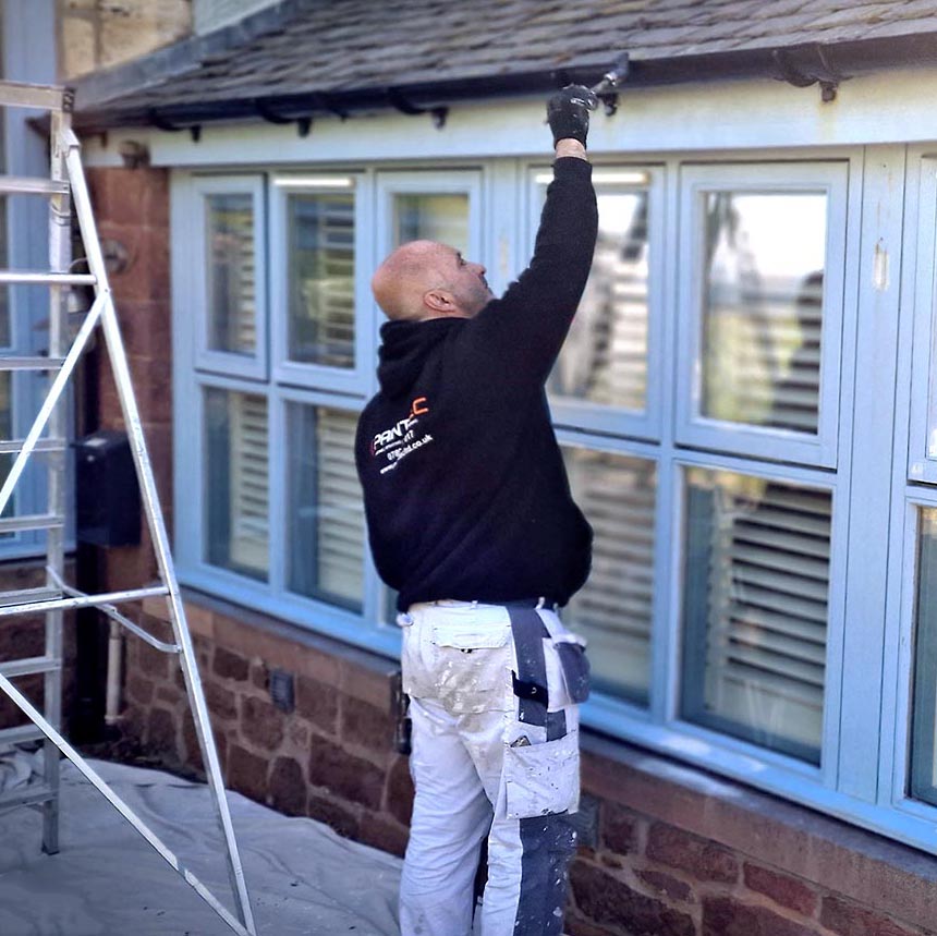 Painter painting exterior of a building