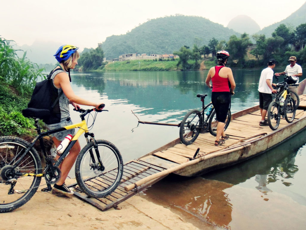 Cycling tour team cross the river