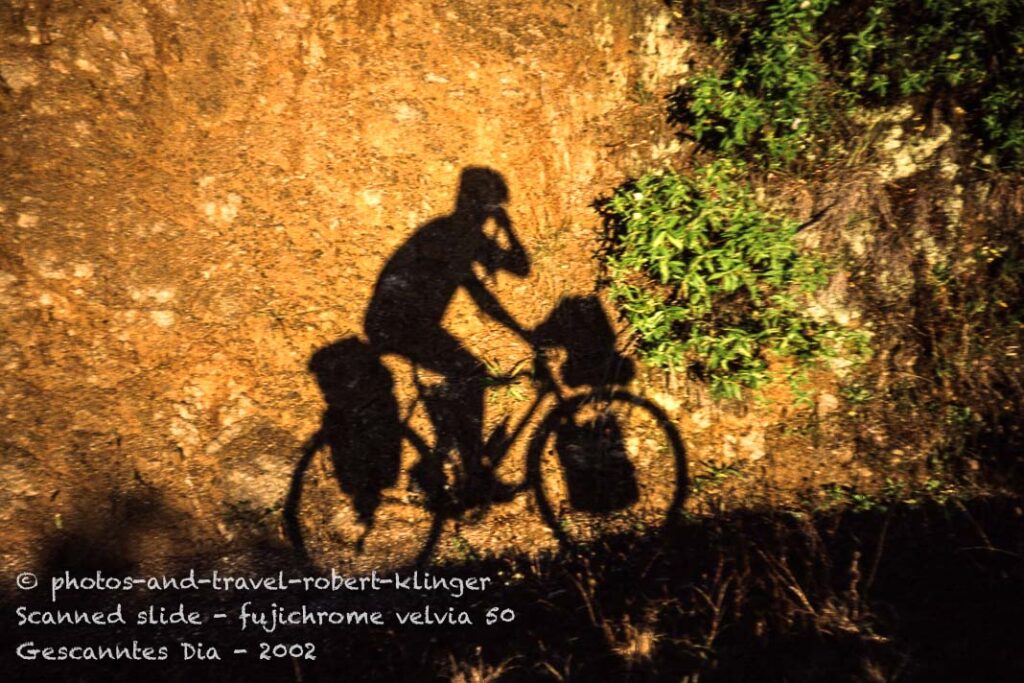 The shadow of a cyclist in the evening sun